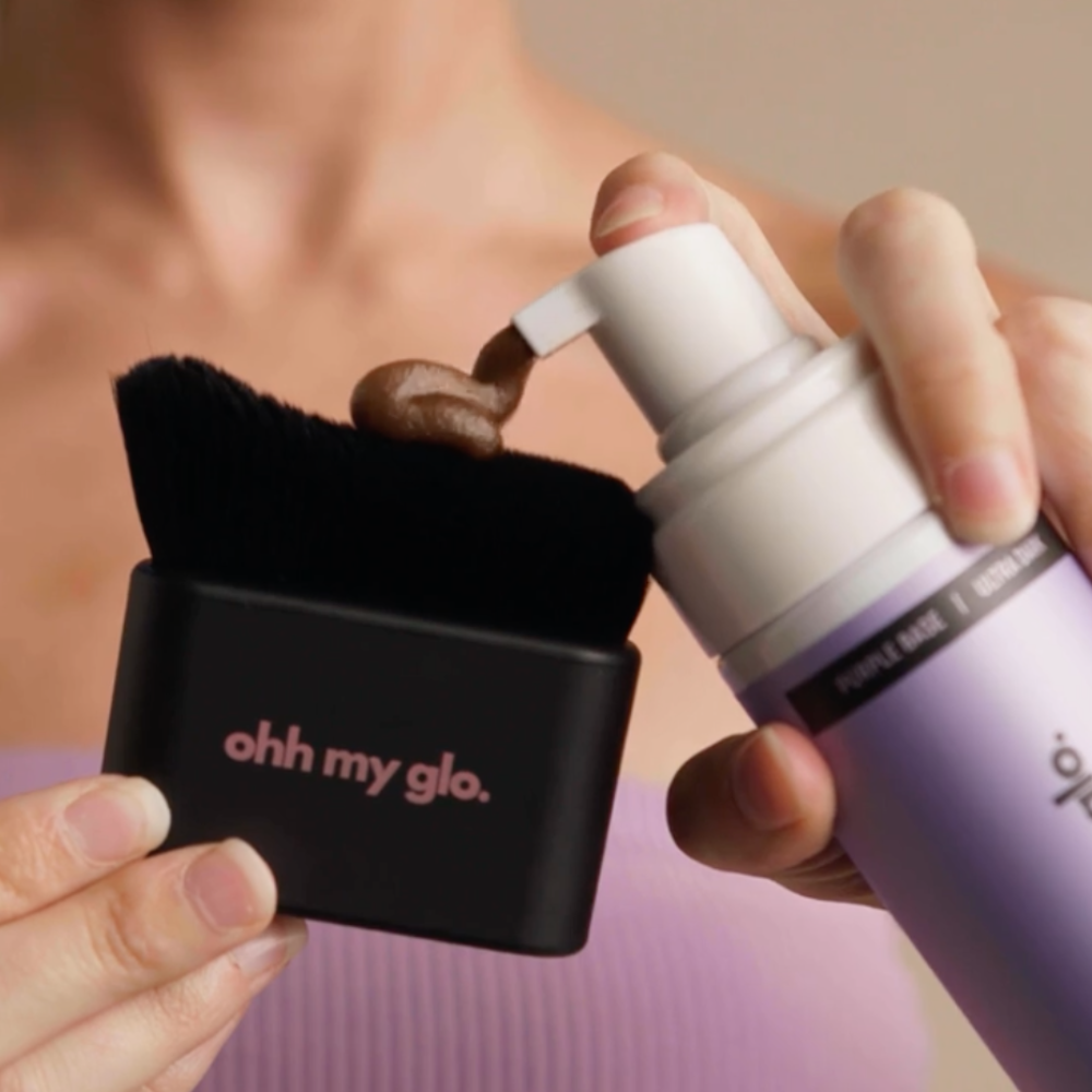 Woman using Ohh My Glo Blending Brush to smooth out self-tan around wrists and ankles