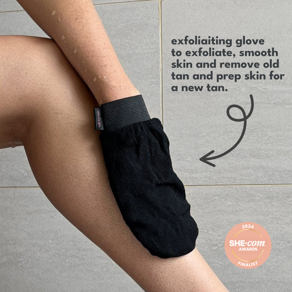 Person using an exfoliating glove on a tiled floor with text about its benefits.