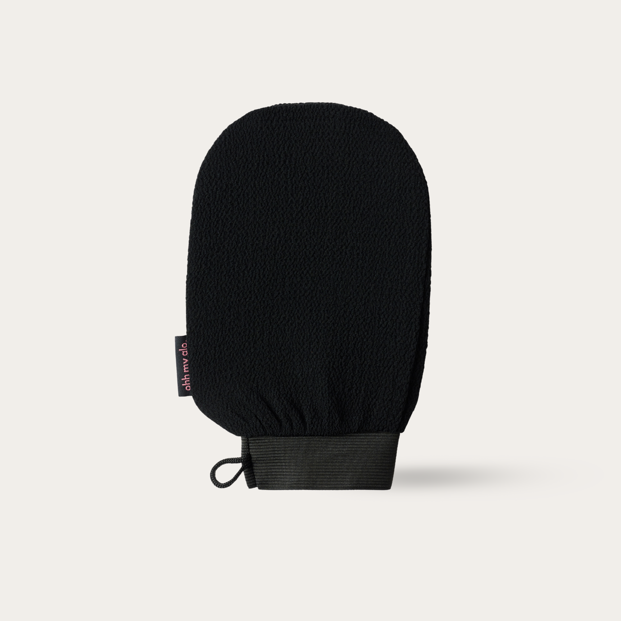 Ohh My Glo Exfoliating Glove product image on beige background