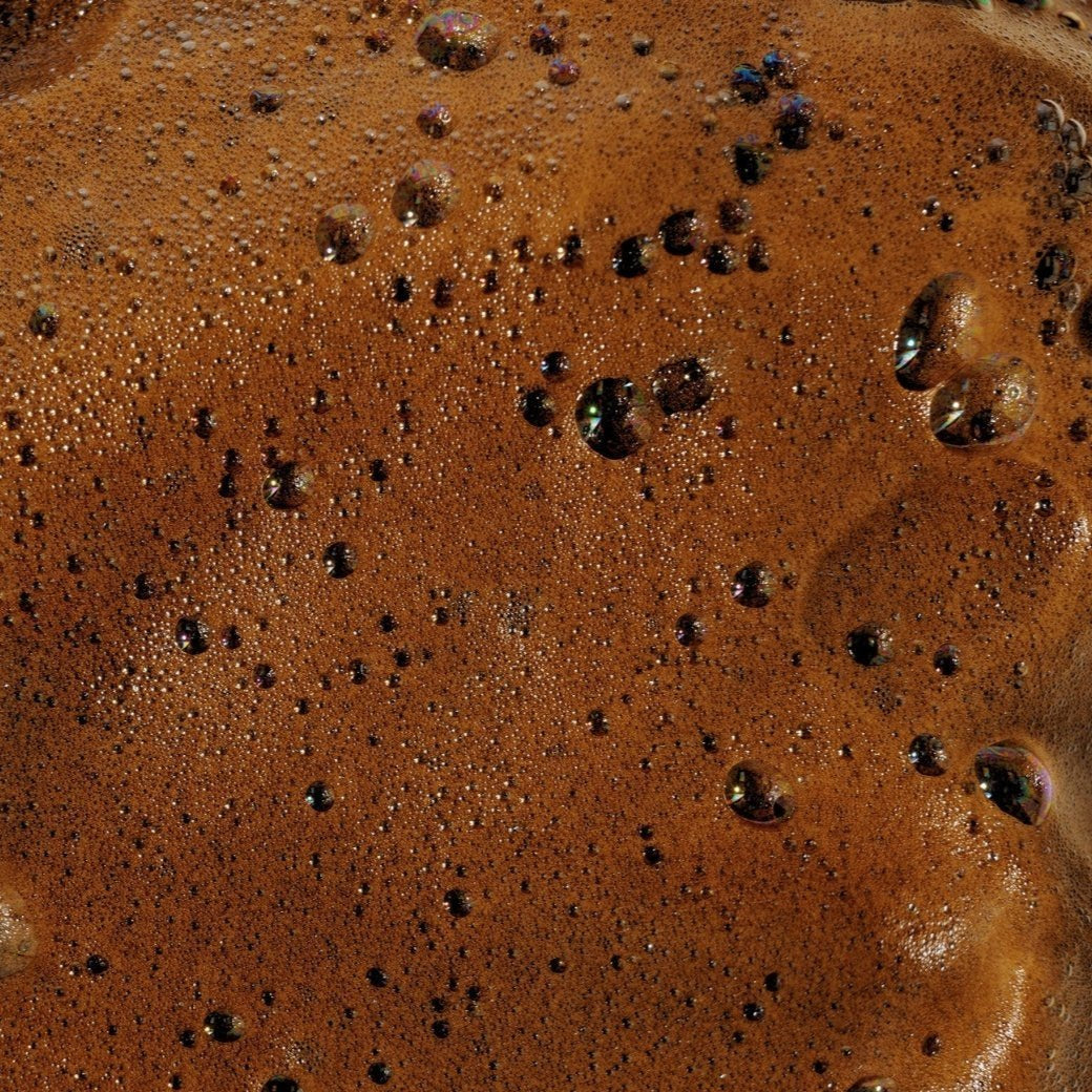 Close-up of Ohh My Glo Medium Dark Green Base Tan mousse texture showing rich formula