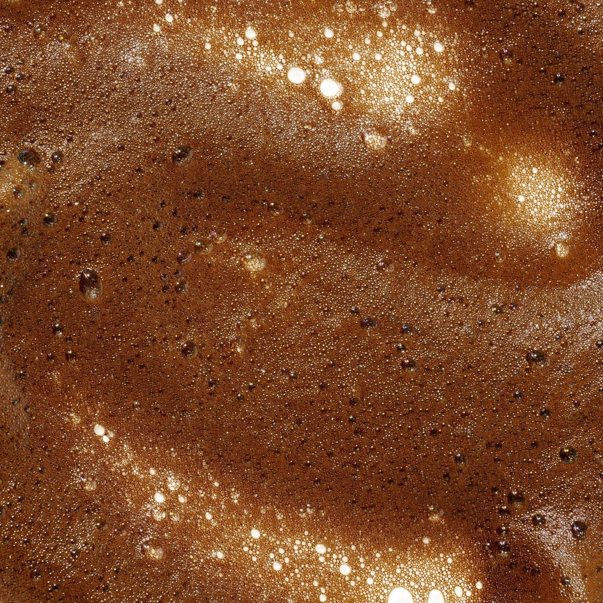 Close-up of Ohh My Glo Medium Dark Purple Base Tan mousse texture showing smooth finish