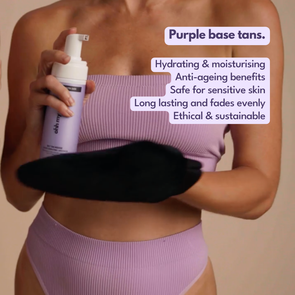Model applying Ohh My Glo Purple Base Tan Mousse using tanning mitt